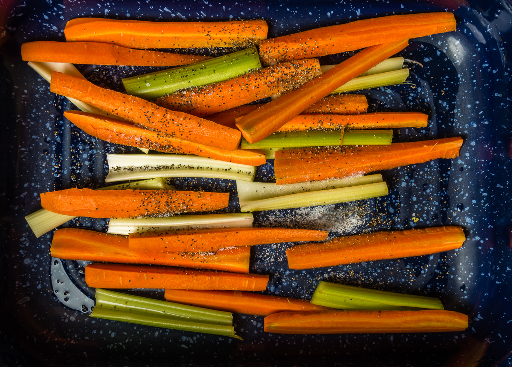 Carrots and celery in roasting pan